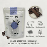 Poodlewohl Bio-Rind Streifen Rezepturbild mit 86 Prozent Bio-Rind, Kokosmehl, Chiamehl, Flohsamen und biobasierter Verpackung
